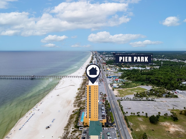 drone / aerial view with a water view and a beach view