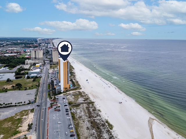 birds eye view of property featuring a beach view and a water view