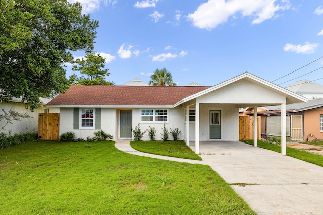 ranch-style home with a front lawn and a carport