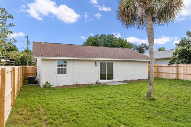 back of property featuring a lawn, a patio, and central air condition unit