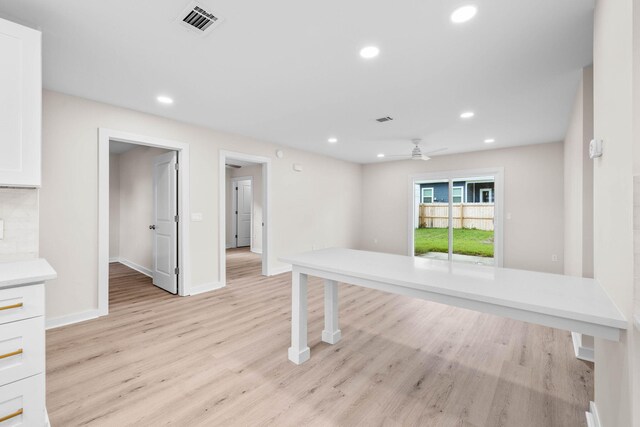 spare room featuring light wood-type flooring and ceiling fan