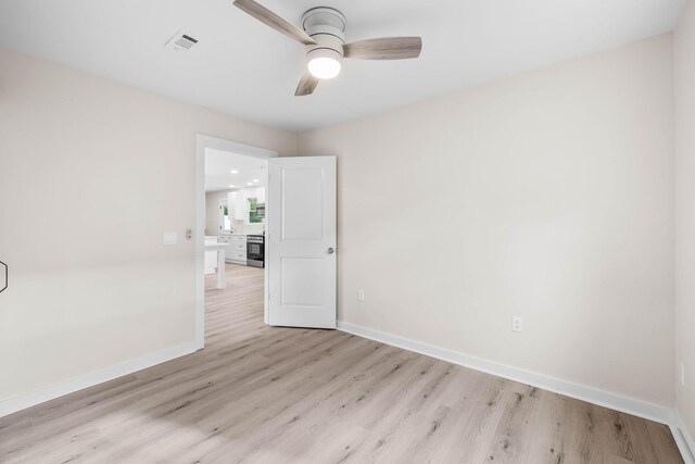 unfurnished room with ceiling fan and light hardwood / wood-style flooring