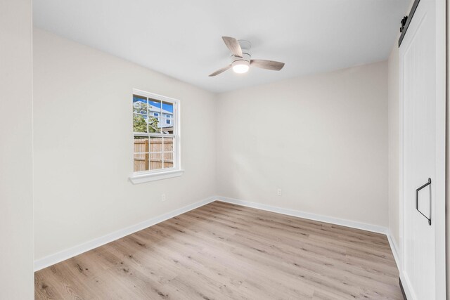 empty room featuring ceiling fan and light wood-type flooring