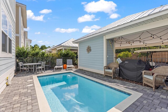 view of swimming pool with area for grilling and a patio area