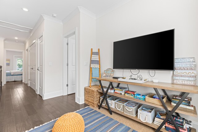 living room with ornamental molding and dark wood-type flooring