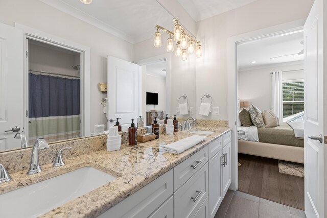 bathroom with ornamental molding, wood-type flooring, vanity, and curtained shower