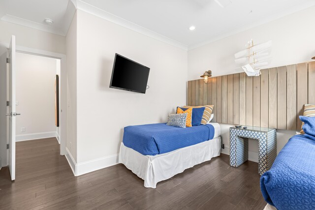 bedroom with crown molding and dark wood-type flooring