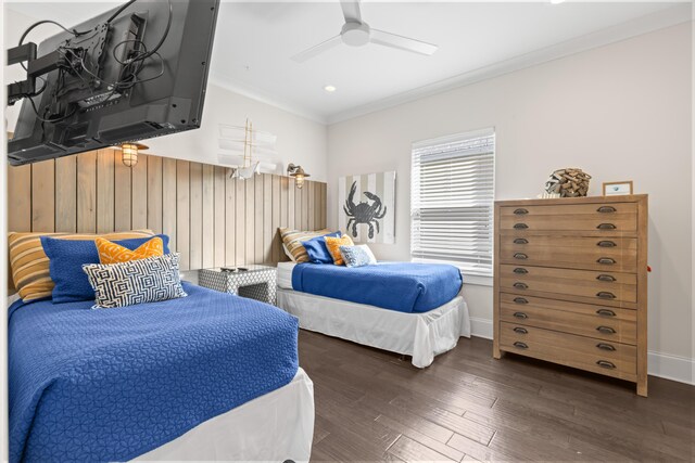 bedroom with ornamental molding, ceiling fan, and dark wood-type flooring