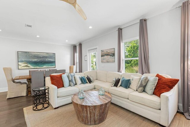 living room featuring hardwood / wood-style flooring and crown molding