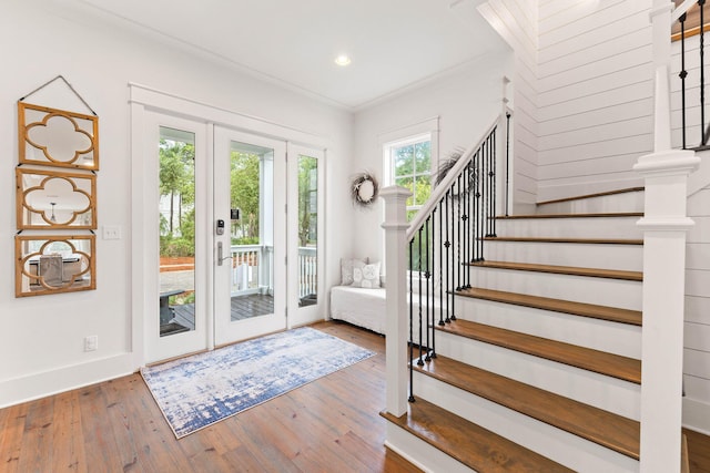 foyer featuring wood-type flooring and ornamental molding