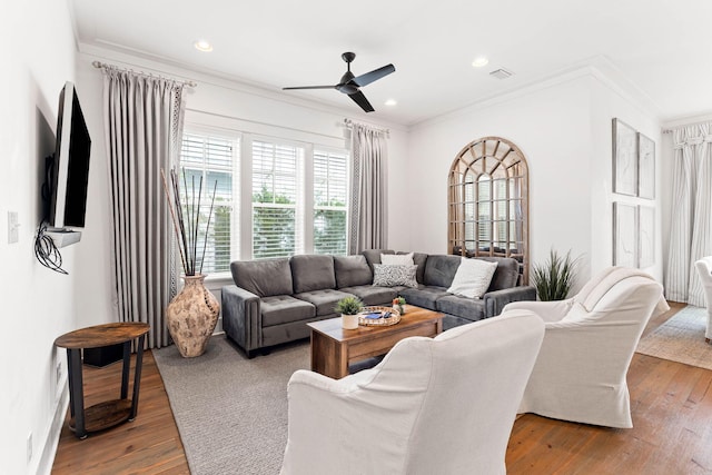 living room with ornamental molding, hardwood / wood-style flooring, and ceiling fan