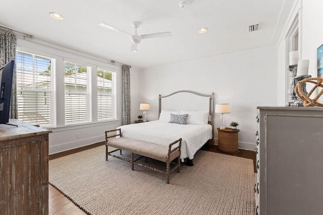 bedroom with ceiling fan, ornamental molding, and light hardwood / wood-style floors