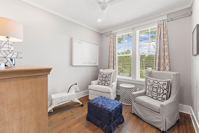 living area featuring crown molding, wood-type flooring, and plenty of natural light