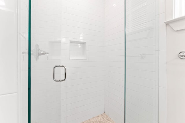 bathroom featuring a shower with door