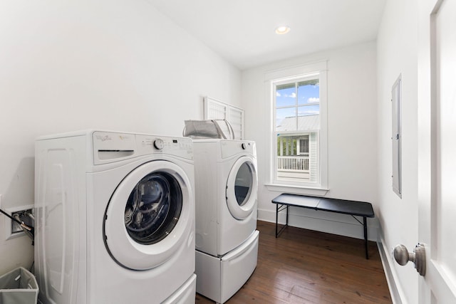 washroom with dark wood-type flooring and washing machine and clothes dryer