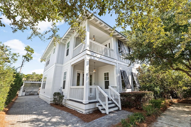 view of front of property with a balcony and a porch