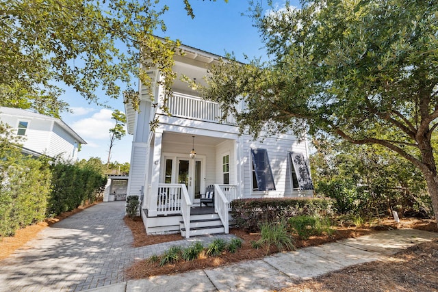 view of front of house with covered porch and a balcony