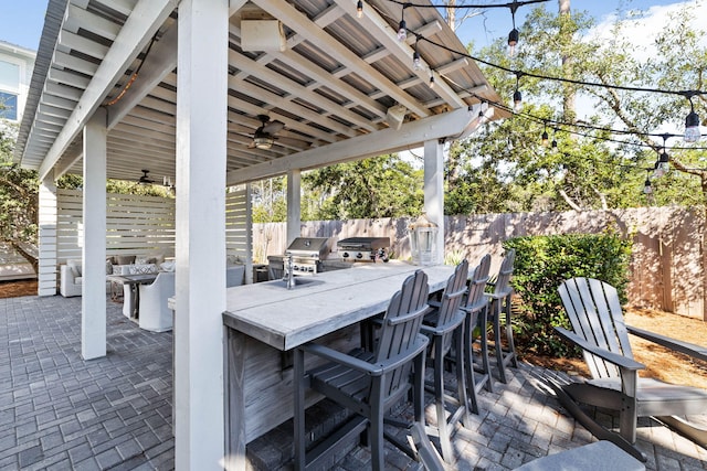 view of patio featuring ceiling fan and a grill