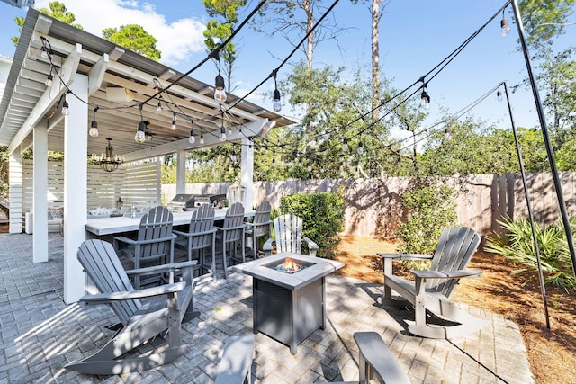 view of patio with area for grilling, a fire pit, and ceiling fan