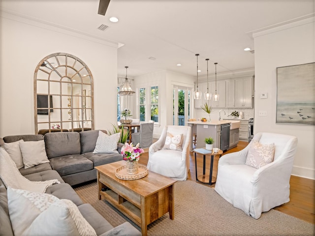 47 Trail Ln, Santa Rosa Beach, FL 32459 - living area with wood finished floors, recessed lighting, ornamental molding, and a chandelier