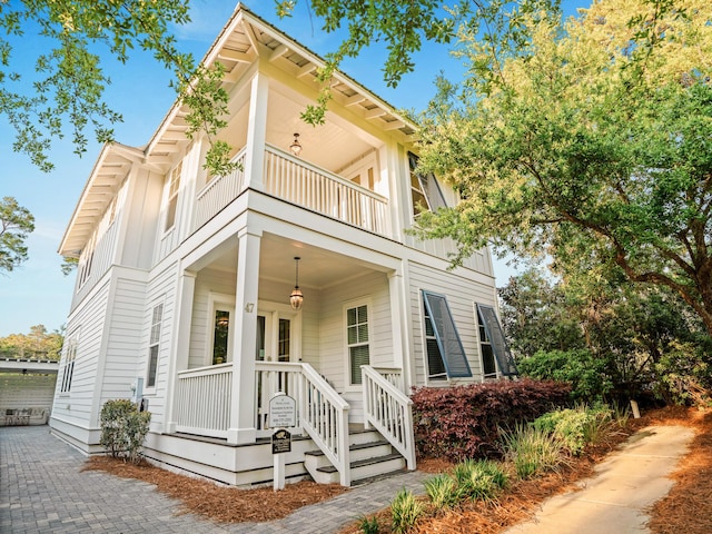 47 Trail Ln, Santa Rosa Beach, FL 32459 - view of front facade with a balcony, board and batten siding, and a porch
