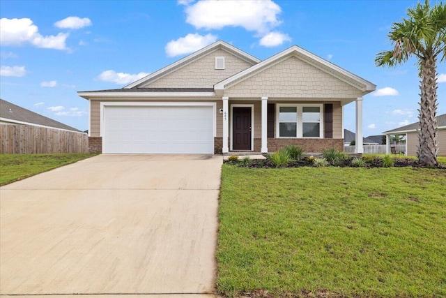 view of front of property featuring a garage, a porch, and a front lawn