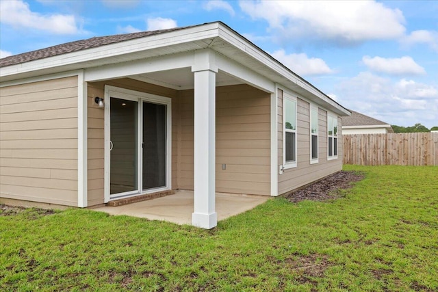 rear view of house with a yard and a patio area