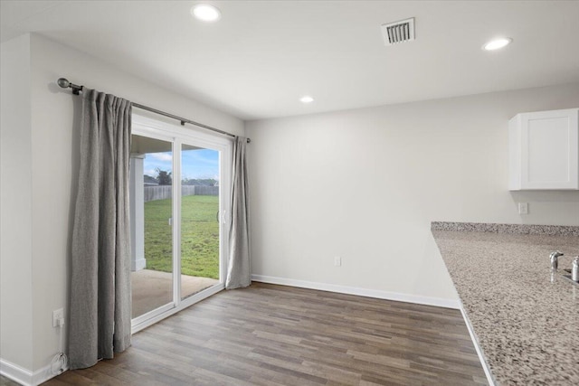 unfurnished dining area with hardwood / wood-style flooring