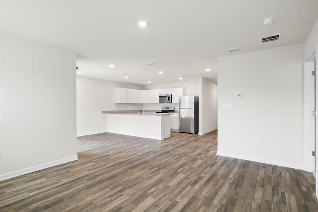 unfurnished living room with dark hardwood / wood-style flooring