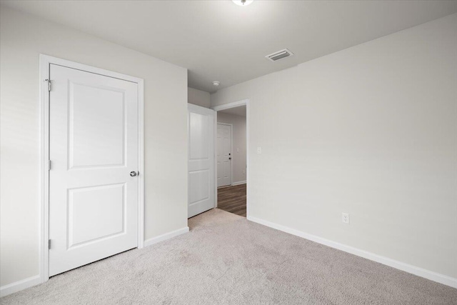 unfurnished bedroom with light colored carpet