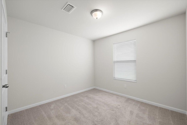 spare room with light carpet