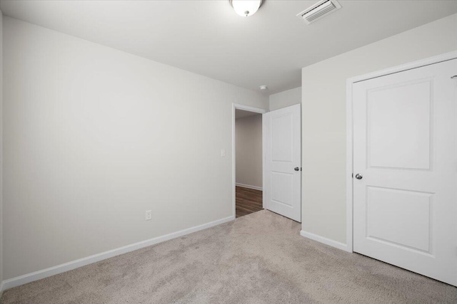 unfurnished bedroom with light carpet