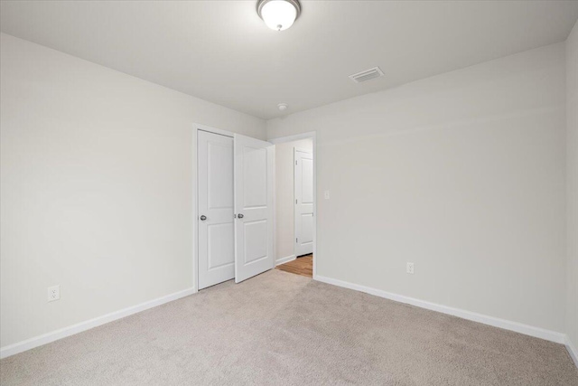 unfurnished bedroom featuring light colored carpet