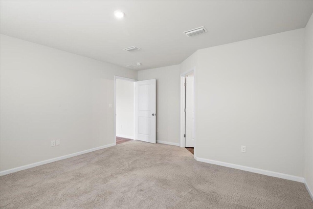 spare room with light colored carpet