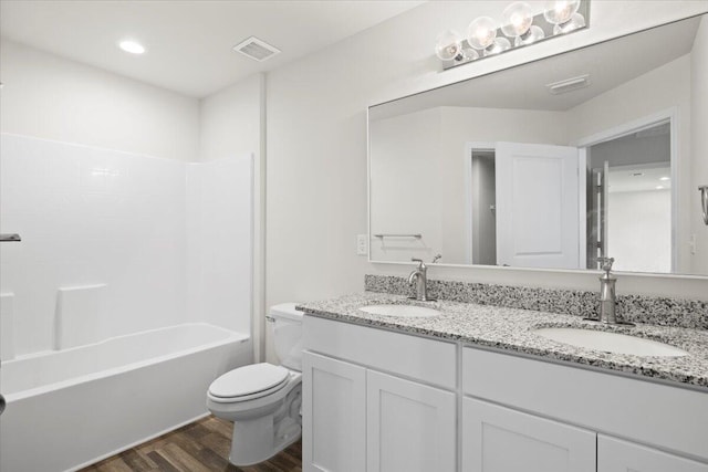 full bathroom with  shower combination, vanity, hardwood / wood-style floors, and toilet