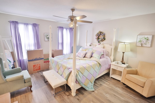 bedroom with ceiling fan and wood-type flooring