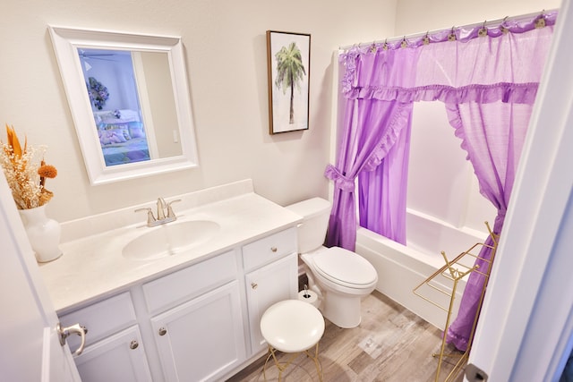 full bathroom featuring vanity, toilet, shower / bathtub combination with curtain, and hardwood / wood-style flooring