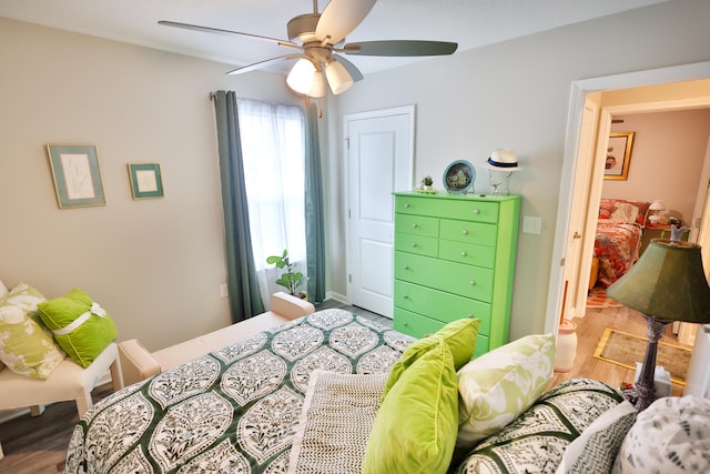 bedroom with hardwood / wood-style floors and ceiling fan