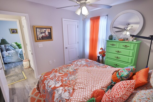 bedroom with wood-type flooring and ceiling fan