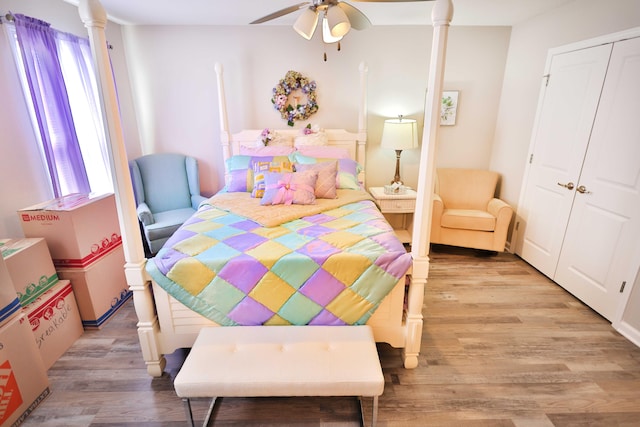 bedroom featuring multiple windows, light hardwood / wood-style floors, and ceiling fan