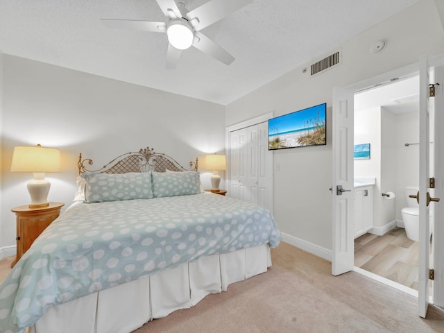 bedroom featuring visible vents, a closet, light carpet, baseboards, and ceiling fan