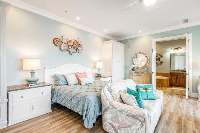 bedroom featuring ensuite bath, light hardwood / wood-style flooring, ceiling fan, and ornamental molding