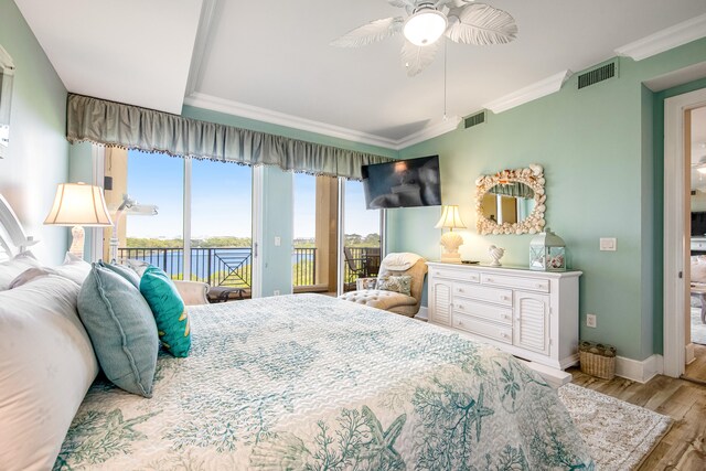 bedroom featuring access to outside, multiple windows, ceiling fan, and hardwood / wood-style floors