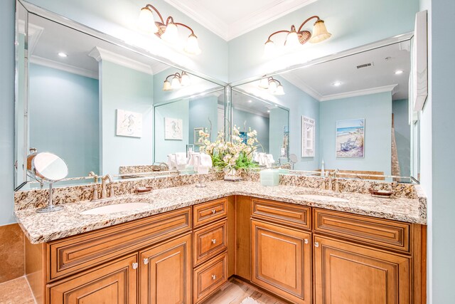 bathroom with vanity and ornamental molding