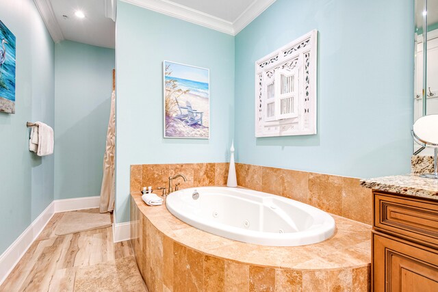 bathroom with hardwood / wood-style floors, vanity, a relaxing tiled tub, and crown molding