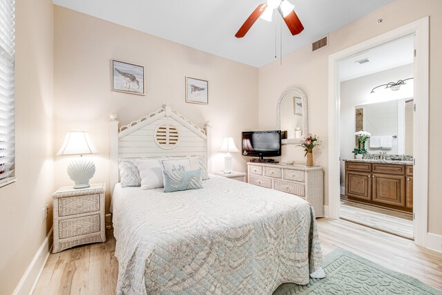 bedroom with ceiling fan, light hardwood / wood-style floors, and connected bathroom