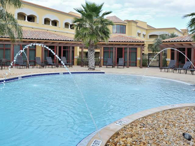 view of swimming pool with pool water feature