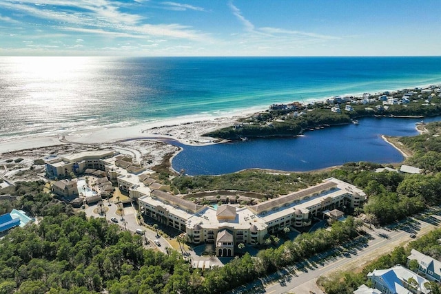 drone / aerial view with a beach view and a water view