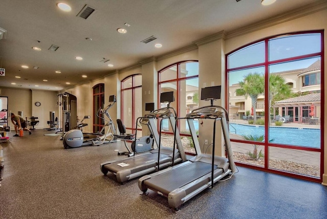 exercise room featuring plenty of natural light and ornamental molding