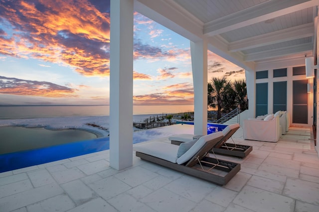 patio terrace at dusk with a water view